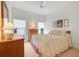 Comfortable bedroom with neutral decor, carpeted floors, bright windows, and plenty of closet space at 21226 Royal St Georges Ln, Leesburg, FL 34748