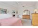 Bright primary bedroom boasts tray ceilings, carpet flooring, and ample closet space with ensuite bathroom access at 21226 Royal St Georges Ln, Leesburg, FL 34748