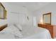 Well-lit primary bedroom with a soft color palette, closet, and dresser with mirror at 21226 Royal St Georges Ln, Leesburg, FL 34748