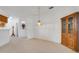 Dining room with neutral carpet and a cabinet for storage at 21226 Royal St Georges Ln, Leesburg, FL 34748