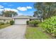 Charming home with a two-car garage, neat landscaping, and a paver driveway at 21226 Royal St Georges Ln, Leesburg, FL 34748