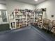Well-organized game room featuring extensive shelving and seating at 21226 Royal St Georges Ln, Leesburg, FL 34748