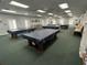 Large game room with multiple covered pool tables and ample lighting at 21226 Royal St Georges Ln, Leesburg, FL 34748