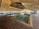 Indoor swimming pool surrounded by tiled decks and lounge chairs under a skylight at 21226 Royal St Georges Ln, Leesburg, FL 34748