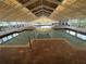 Indoor swimming pool featuring an atrium-style roof and tiled decking at 21226 Royal St Georges Ln, Leesburg, FL 34748