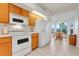 Well-lit kitchen features modern appliances and a breakfast nook with natural light at 21226 Royal St Georges Ln, Leesburg, FL 34748