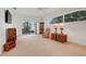 Spacious living room with sliding doors leading to the outside, carpeted floors, and large window at 21226 Royal St Georges Ln, Leesburg, FL 34748