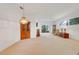 Spacious living room with carpet, light walls, and sliding glass doors leading to the outside at 21226 Royal St Georges Ln, Leesburg, FL 34748
