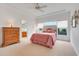 Bright main bedroom featuring a large window, plush carpet, and an ensuite bathroom at 21226 Royal St Georges Ln, Leesburg, FL 34748