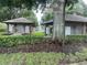View of two pool house buildings with an American flag in the background at 21226 Royal St Georges Ln, Leesburg, FL 34748