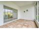 Enclosed sunroom features a textured wall, decorative frogs, and sliding glass doors to the outside at 21226 Royal St Georges Ln, Leesburg, FL 34748