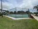 View of a fenced tennis court with well-maintained green and blue playing surface at 21226 Royal St Georges Ln, Leesburg, FL 34748
