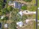 Expansive aerial view showcasing the home's large lot, mature trees, long driveway, and proximity to nearby community at 2216 River Ridge Rd, Deland, FL 32720