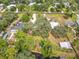 Expansive aerial view showcasing homes with lush landscaping and the canal running behind several homes and new dock at 2216 River Ridge Rd, Deland, FL 32720