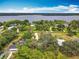Expansive aerial view showcasing waterfront homes with lush landscaping and the canal running behind several homes at 2216 River Ridge Rd, Deland, FL 32720