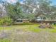 Large backyard features mature trees, a fire pit and a shed at 2216 River Ridge Rd, Deland, FL 32720