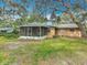 Lovely backyard featuring mature trees, a screened-in porch and a well-maintained lawn at 2216 River Ridge Rd, Deland, FL 32720