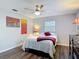 Cozy bedroom featuring a ceiling fan, gray walls, and wood-look floors at 2216 River Ridge Rd, Deland, FL 32720
