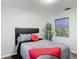 Bedroom featuring an elegant gray bed set and bamboo plant at 2216 River Ridge Rd, Deland, FL 32720