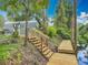 Newly constructed wooden dock with stairs leading to a lush, green yard, offering waterfront access and a touch of nature at 2216 River Ridge Rd, Deland, FL 32720