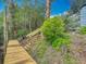 Newly constructed wooden dock with stairs leading to a lush, green yard, offering waterfront access and a touch of nature at 2216 River Ridge Rd, Deland, FL 32720