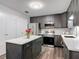 Updated kitchen features dark cabinets, stainless appliances, and marble countertops at 2216 River Ridge Rd, Deland, FL 32720