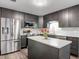 Modern kitchen featuring stainless steel appliances, a center island, and sleek cabinetry for a contemporary feel at 2216 River Ridge Rd, Deland, FL 32720