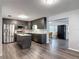 Spacious kitchen with island featuring dark cabinets, stainless appliances, and marble countertops at 2216 River Ridge Rd, Deland, FL 32720