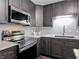 Updated kitchen features dark cabinets, stainless appliances, and marble countertops at 2216 River Ridge Rd, Deland, FL 32720
