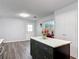 Spacious kitchen with island featuring dark cabinets, stainless appliances, and marble countertops at 2216 River Ridge Rd, Deland, FL 32720