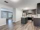 Spacious kitchen with island featuring dark cabinets, stainless appliances, and marble countertops at 2216 River Ridge Rd, Deland, FL 32720