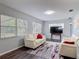 Bright living room features two white couches, windows, and laminate flooring at 2216 River Ridge Rd, Deland, FL 32720