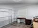 Office space with wood-look floors, storage shelving, two windows, and desk at 2216 River Ridge Rd, Deland, FL 32720
