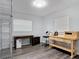 Office space with wood-look floors, storage shelving, two windows, and desks at 2216 River Ridge Rd, Deland, FL 32720