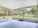 View of the expansive backyard from inside the home's screened-in back porch at 2216 River Ridge Rd, Deland, FL 32720