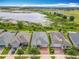 Scenic aerial view of a residential neighborhood with a beautiful lake, trails, and well-manicured lawns at 224 Silver Maple Rd, Groveland, FL 34736