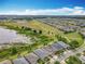 Beautiful aerial view of a neighborhood with a lake and walking trails, near well-maintained homes and green spaces at 224 Silver Maple Rd, Groveland, FL 34736