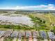 Stunning aerial view of a lakeside neighborhood showcases beautiful homes with manicured lawns and plenty of green space at 224 Silver Maple Rd, Groveland, FL 34736