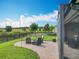 Charming outdoor patio with comfortable seating, ideal for enjoying the beautiful landscaping and picturesque views at 224 Silver Maple Rd, Groveland, FL 34736