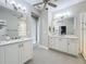 This bathroom is well lit with double vanity, shower and commode at 224 Silver Maple Rd, Groveland, FL 34736