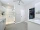A bright, clean bathroom features a glass-enclosed shower and double vanity with storage at 224 Silver Maple Rd, Groveland, FL 34736