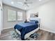 A cozy bedroom featuring a plush rug, natural light, and tasteful decor at 224 Silver Maple Rd, Groveland, FL 34736