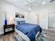 A stylish bedroom featuring wood floors, modern decor, and lots of natural light at 224 Silver Maple Rd, Groveland, FL 34736