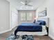 A peaceful bedroom with a large window, comfortable bed, and modern accents at 224 Silver Maple Rd, Groveland, FL 34736