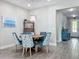 Cozy dining room featuring a modern chandelier, blue accents, and wood-look flooring at 224 Silver Maple Rd, Groveland, FL 34736