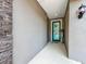 Inviting entryway featuring a decorative stone wall and stylish lighting at 224 Silver Maple Rd, Groveland, FL 34736