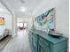 Bright hallway featuring wood-look tile flooring and views of the living spaces at 224 Silver Maple Rd, Groveland, FL 34736
