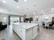 Open-concept kitchen featuring a large island, modern appliances, and seamless access to living spaces at 224 Silver Maple Rd, Groveland, FL 34736