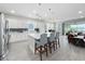 Bright kitchen with stainless steel appliances, white cabinetry, and a large island with seating at 224 Silver Maple Rd, Groveland, FL 34736