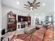 Inviting living room with a ceiling fan, entertainment center, and comfortable seating area at 224 Silver Maple Rd, Groveland, FL 34736